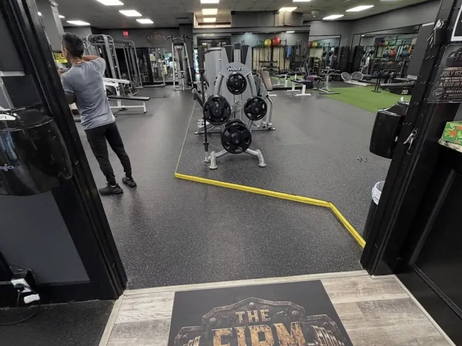 Entrance to The Firm Fitness with Earned Not Given floor mat