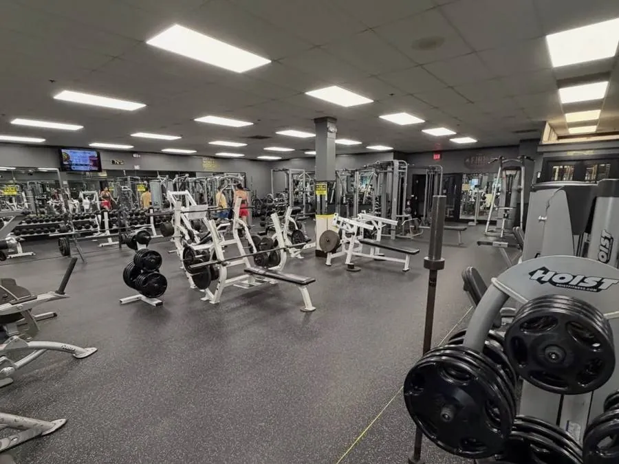 Main training floor at The Firm Fitness in Marlton NJ with benches, racks and free weights